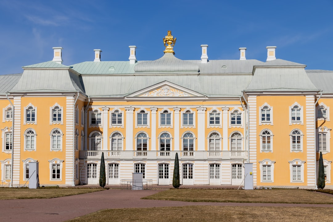 A beautiful, yellow palace stands under a blue sky.
